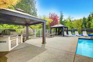 Concrete patio, pool area with barbequel