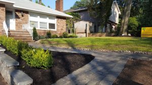 a walk way with a natural stome retaining wall i and garden Tenafly NJ 2