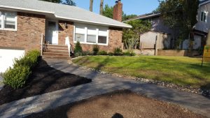 a walk way with a natural stome retaining wall i and garden Tenafly NJ 3