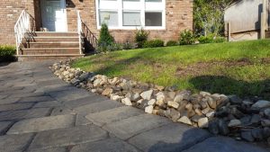 a walk way with a natural stome retaining wall in Tenafly NJ 2